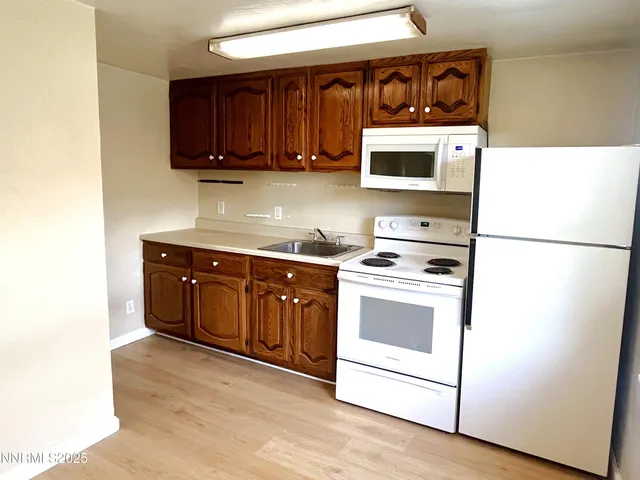 a kitchen with stainless steel appliances granite countertop a stove a microwave and a refrigerator