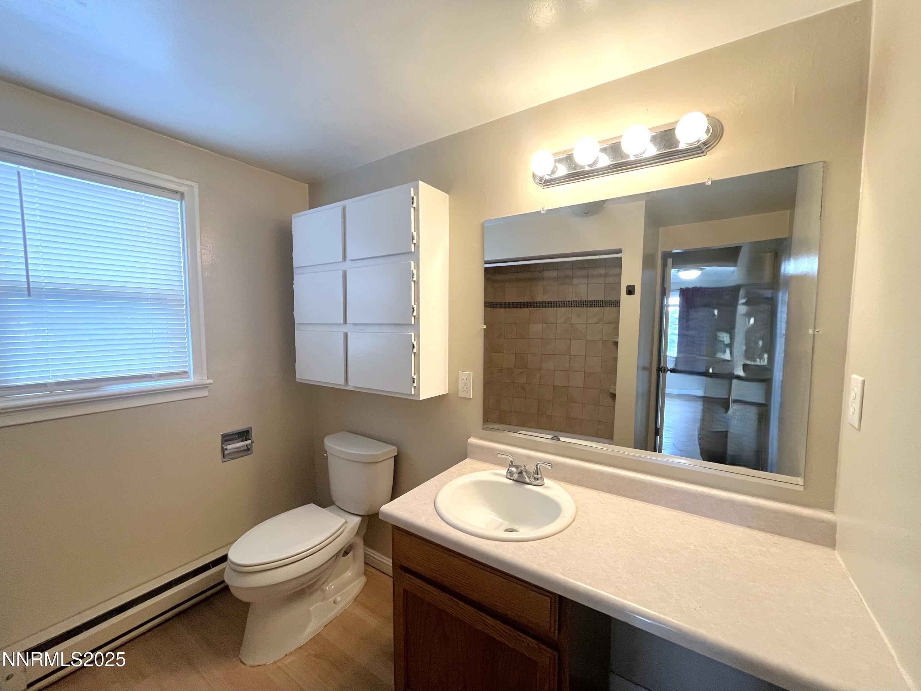 1539 G. Street, Unit C Sparks, NV 89431 - Photo 6 of 6 a bathroom with a sink a toilet and mirror