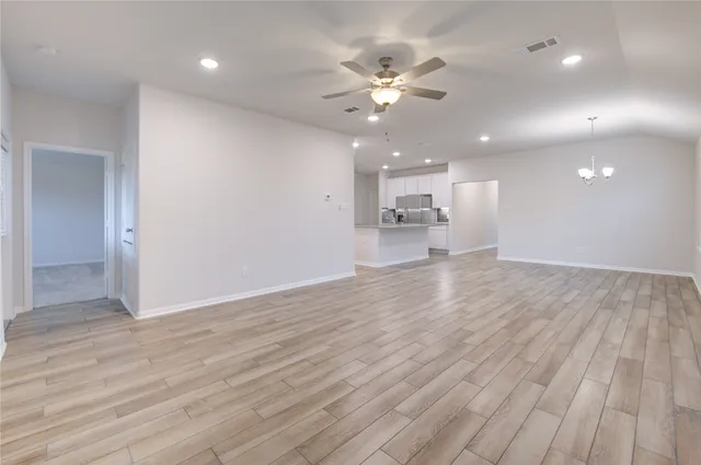 a view of an empty room and wooden floor