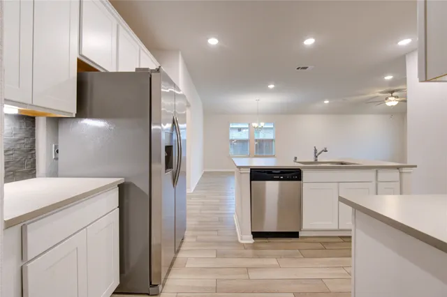 a kitchen with a sink stainless steel appliances and cabinets