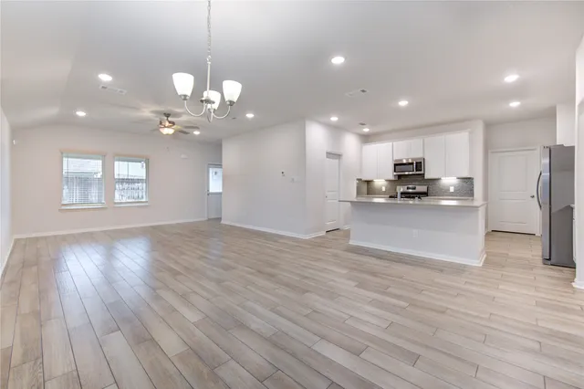 a view of a kitchen with a stove cabinets and wooden floor