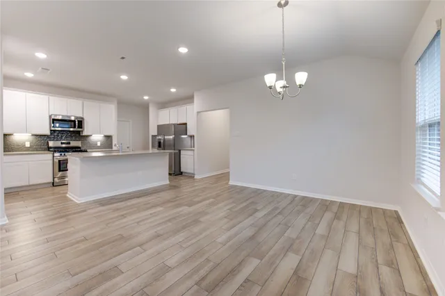 a view of a kitchen with stove and cabinets