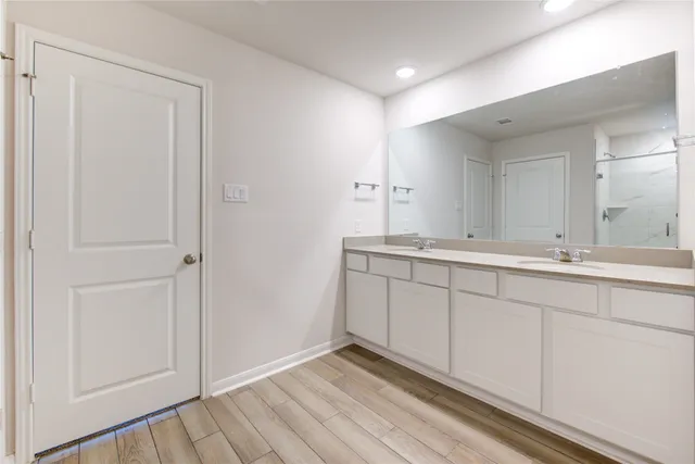 a bathroom with a double vanity sink and mirror