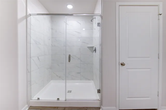 a bathroom with a glass shower door