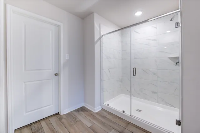 a bathroom with a glass shower door