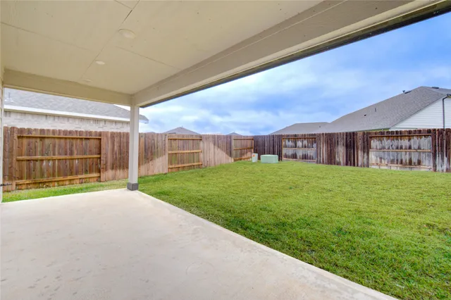 a view of a house with a big yard and large tree