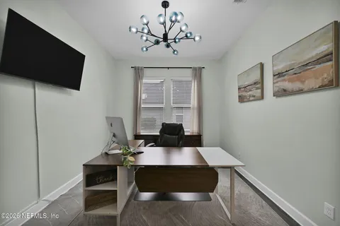 a spacious bathroom with a granite countertop sink and a mirror