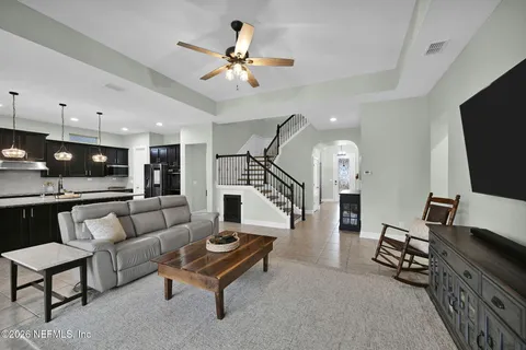 a living room with furniture and a large mirror