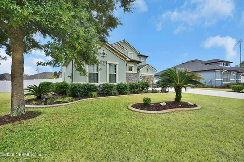 a dining room with furniture a chandelier and wooden floor