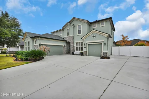 a living room with furniture a chandelier and a flat screen tv