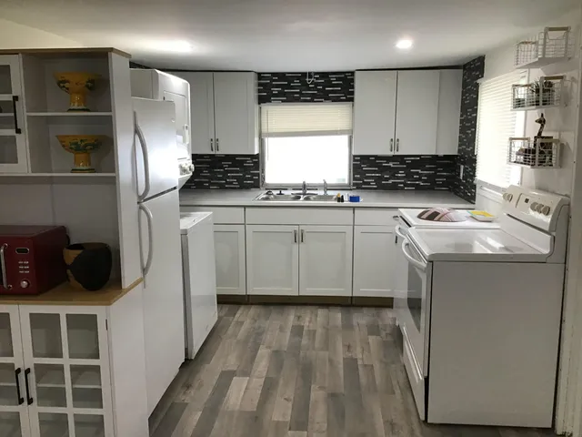 a kitchen with a refrigerator and a stove top oven