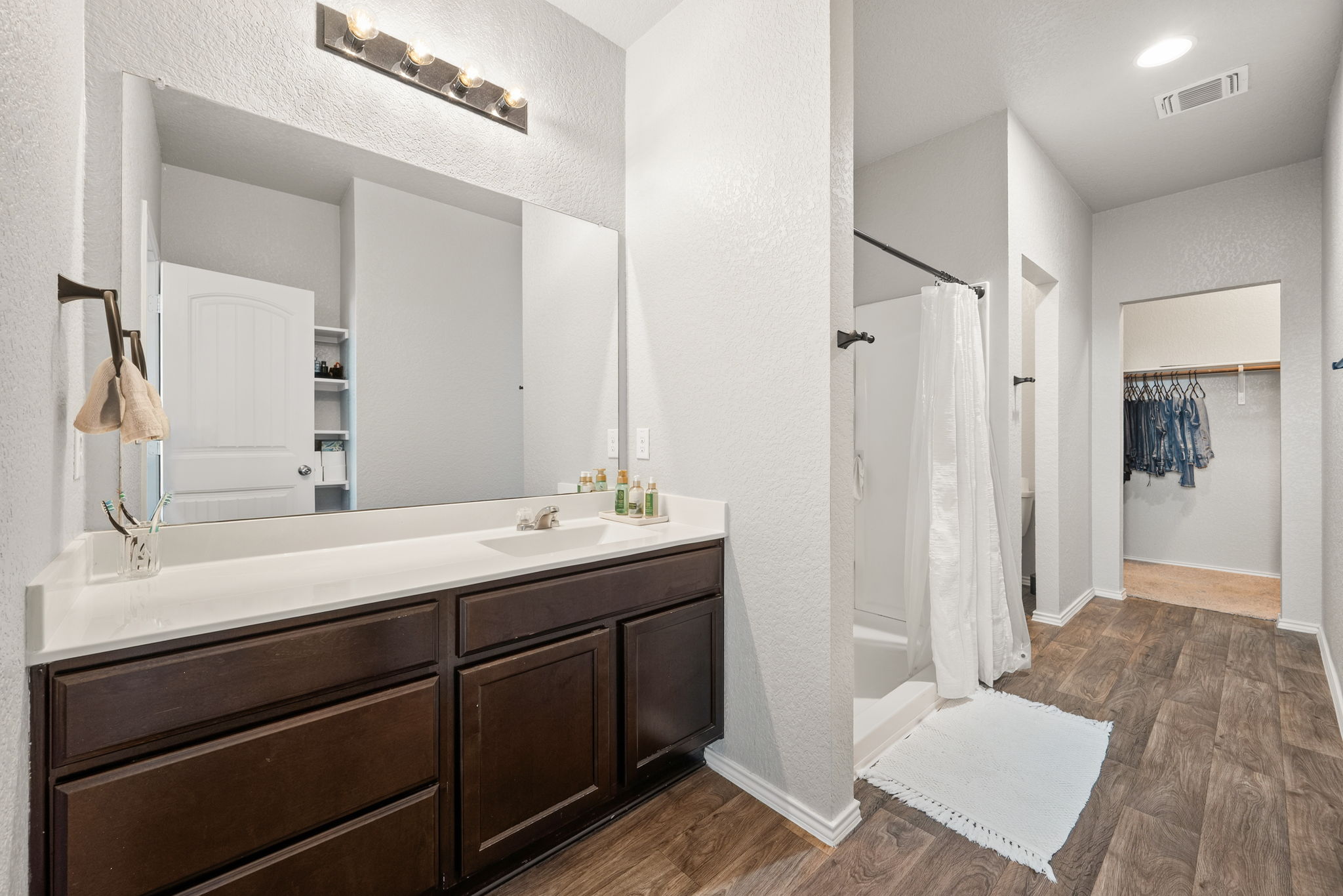 12007 Riprap Drive Manor, TX 78653 - Photo 19 of 37 A well-appointed bathroom featuring a spacious vanity and a convenient walk-in shower.