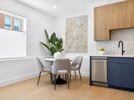 a living room with furniture a table and a potted plant