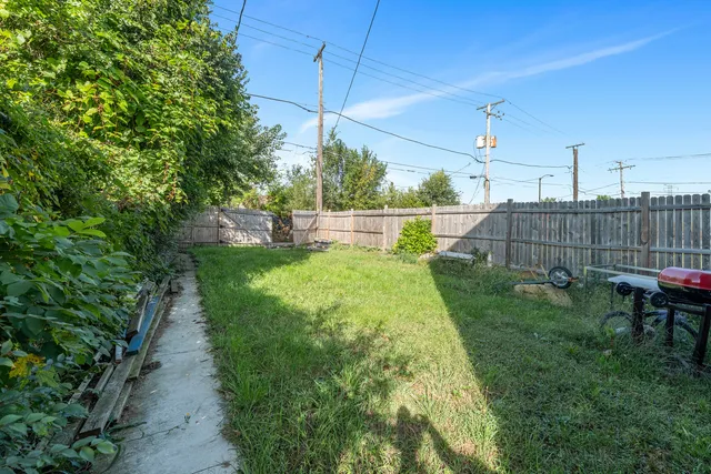 a view of a house with brick walls and a yard