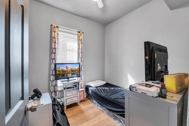 a bedroom with a bed and a window