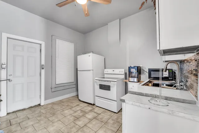 a kitchen with a stove a sink and a refrigerator