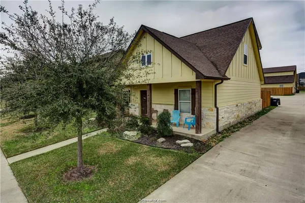 a front view of a house with a yard and porch