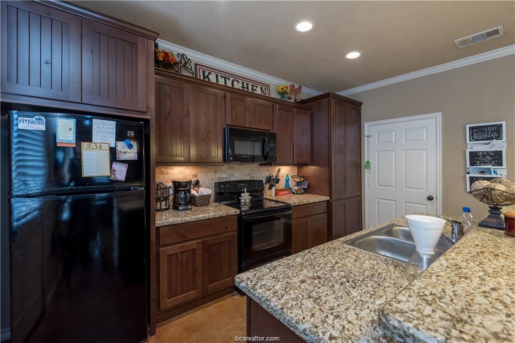 3366 Keefer Loop College Station, TX 77845 - Photo 3 of 11 a kitchen with a refrigerator stove and sink
