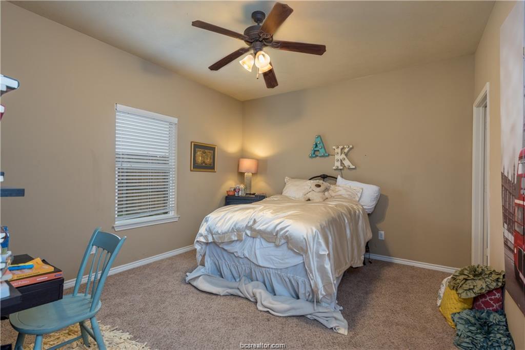 3366 Keefer Loop College Station, TX 77845 - Photo 7 of 11 a bedroom with a bed and a chandelier