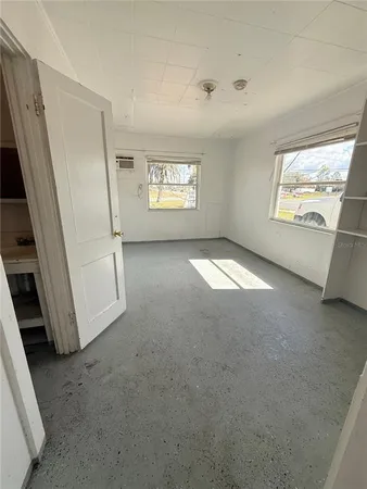 a view of an empty room and a window