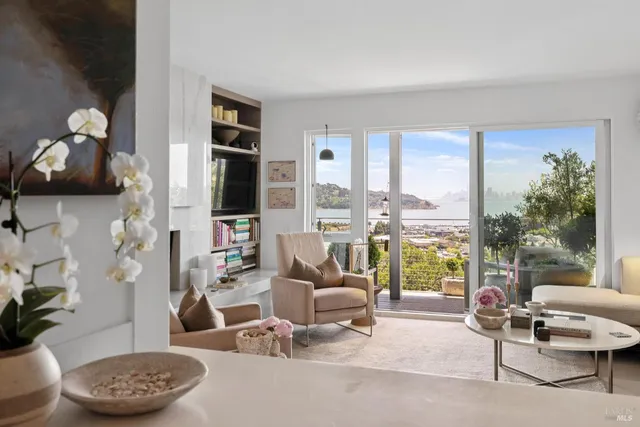 a living room with furniture and a floor to ceiling window