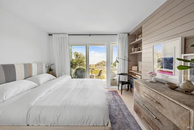 a bed room with a bed and a large window