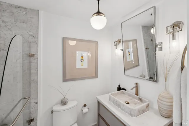 a bathroom with a sink toilet and mirror