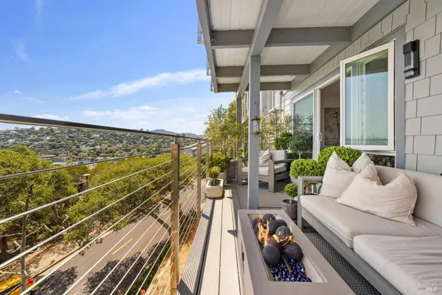 a view of balcony with chairs and wooden floor