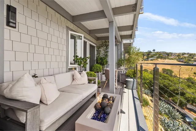 a view of a balcony with lake view and a potted plant