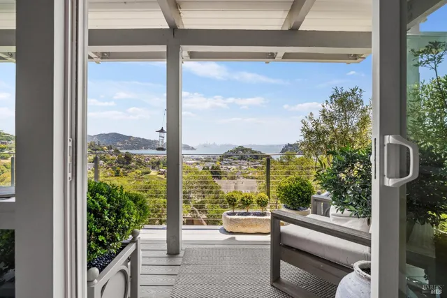 a view of a glass door with a balcony from a room