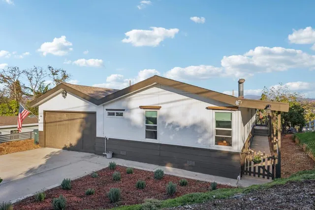 a bathroom with a granite countertop sink mirror vanity and toilet