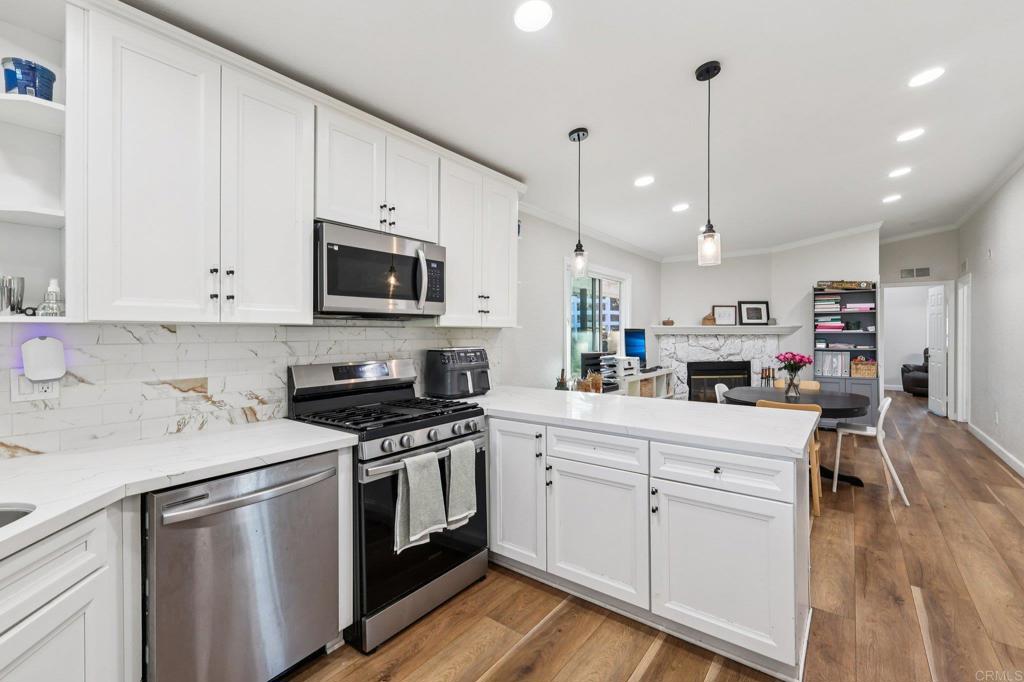 8735 Almond Road Lakeside, CA 92040 - Photo 16 of 71 a kitchen with stainless steel appliances granite countertop a stove a sink and a microwave