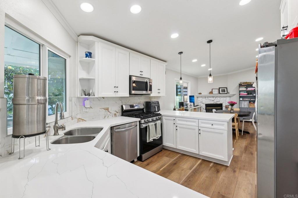 8735 Almond Road Lakeside, CA 92040 - Photo 18 of 71 a kitchen with a sink stainless steel appliances and white cabinets