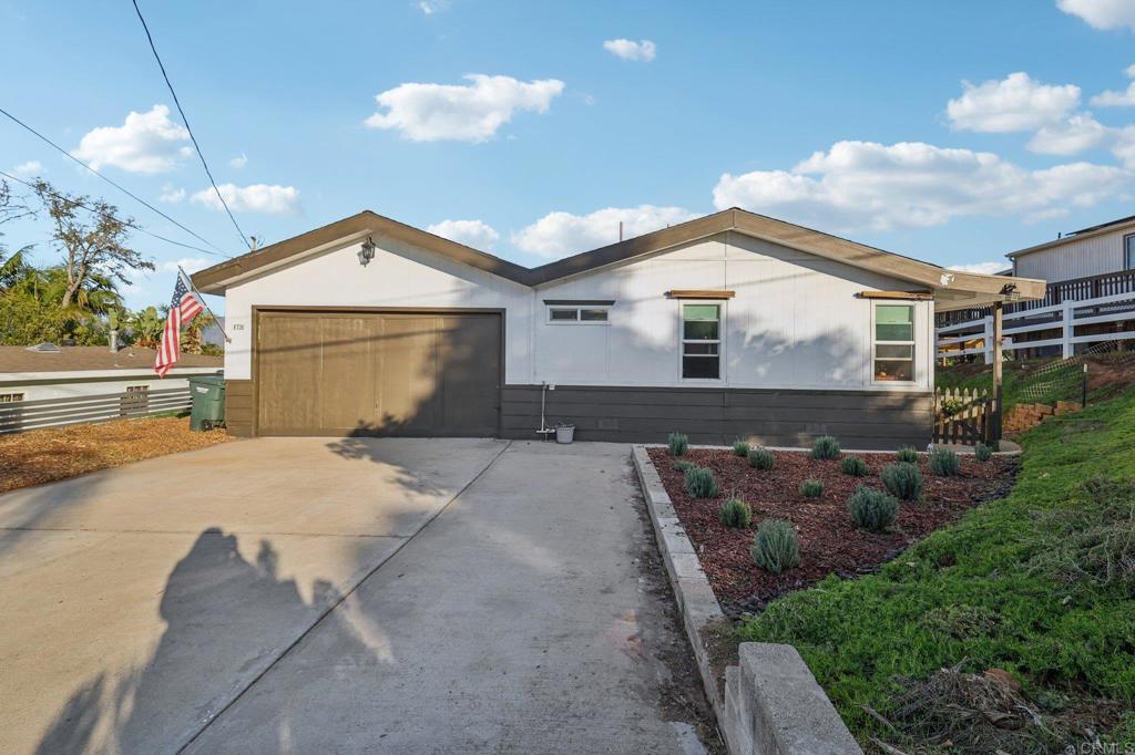 8735 Almond Road Lakeside, CA 92040 - Photo 20 of 71 a front view of a house with a yard and garage