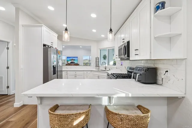 a living room with furniture a piano and a flat screen tv