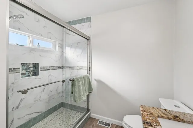 an aerial view of residential house with outdoor space and trees all around