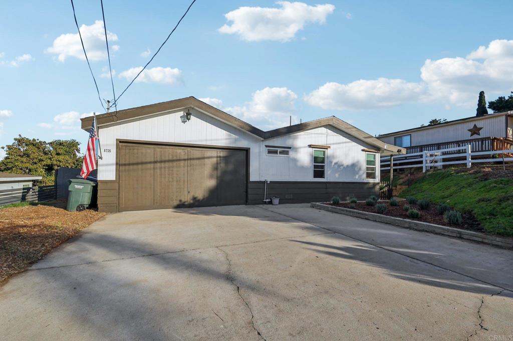 8735 Almond Road Lakeside, CA 92040 - Photo 22 of 71 a front view of a house with a yard and garage