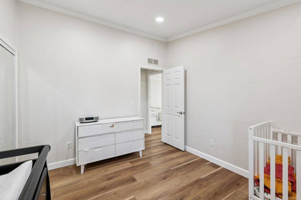 8735 Almond Road Lakeside, CA 92040 - Photo 26 of 71 a view of an empty room with wooden floor and a window