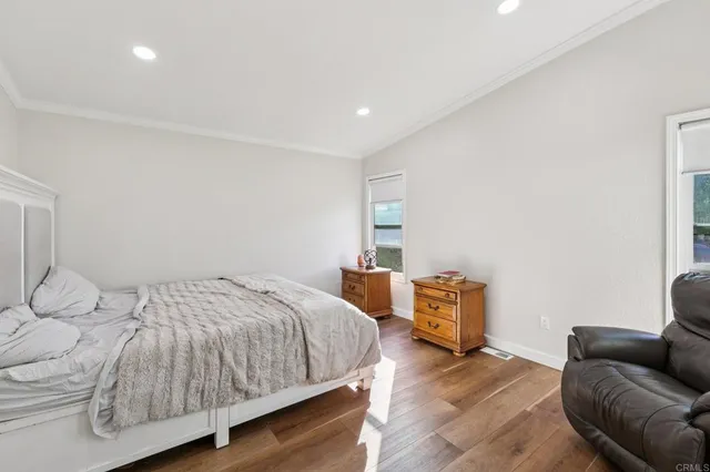 a view of a house with a yard and potted plants