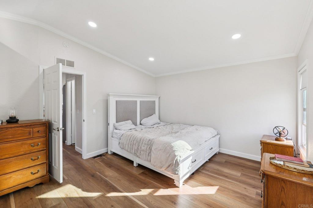 8735 Almond Road Lakeside, CA 92040 - Photo 30 of 71 a bedroom with a bed and wooden floor