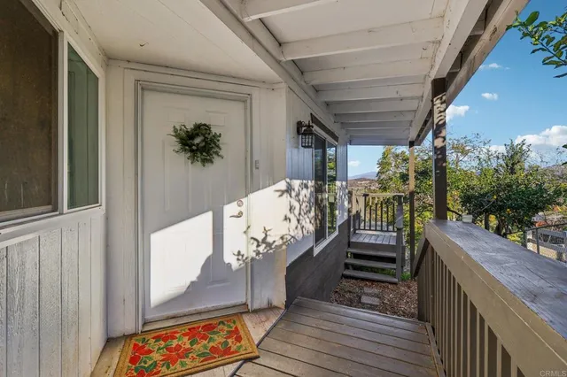 a living room with furniture a fireplace and kitchen view