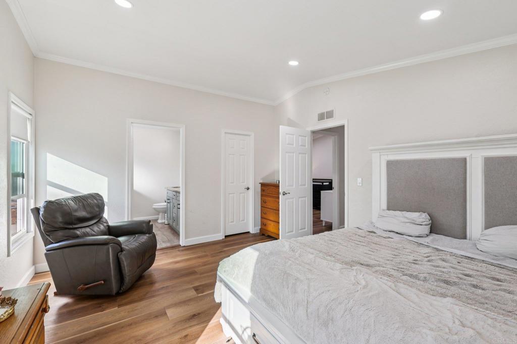 8735 Almond Road Lakeside, CA 92040 - Photo 32 of 71 a bedroom with bed and wooden floor