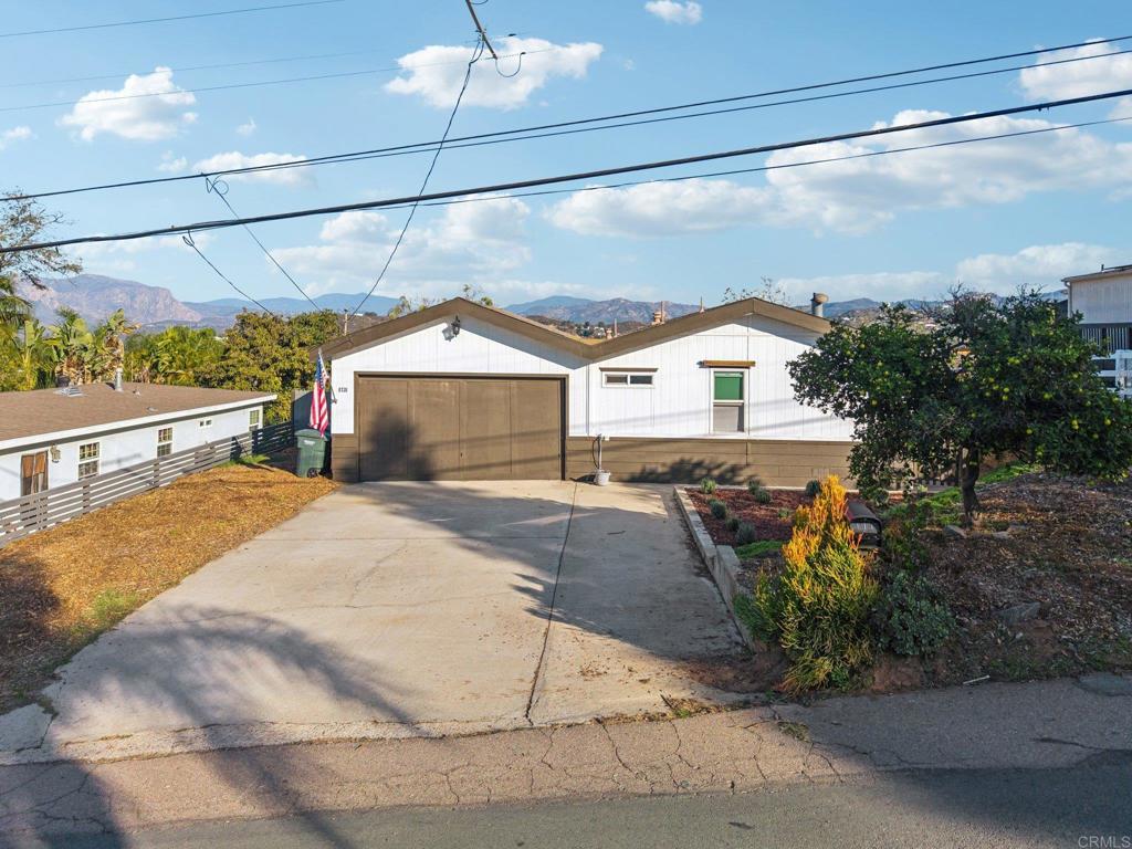 8735 Almond Road Lakeside, CA 92040 - Photo 62 of 71 a view of a house with a yard and potted plants