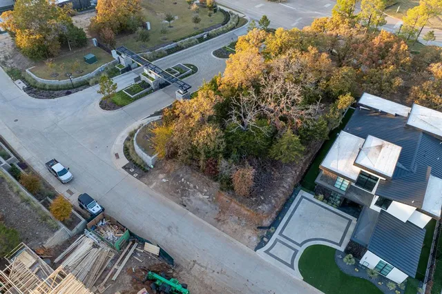 an aerial view of a house with a yard and lake view