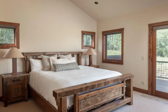 a bed sitting in a bedroom next to a window