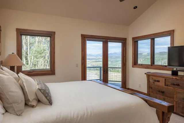 a bedroom with a large bed and a large window