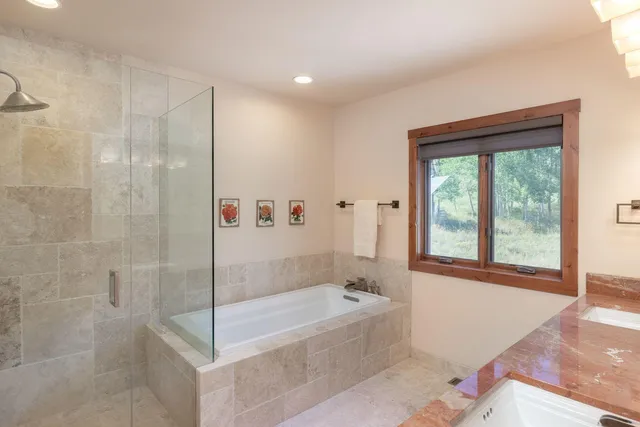 a bathroom with a bathtub and shower