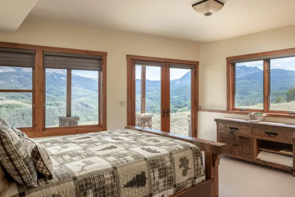 a bedroom with a large bed and a large window