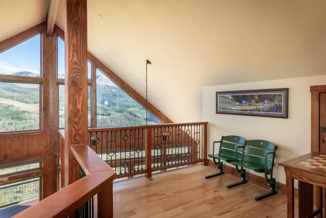 a view of a hallway with wooden floor and stairs