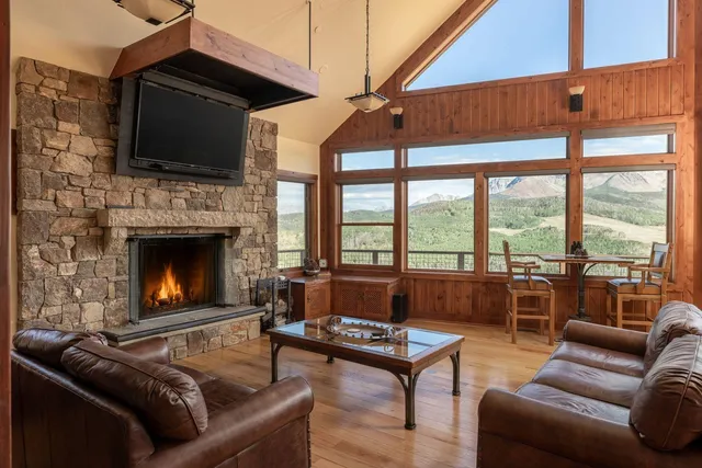 a living room with furniture fireplace and flat screen tv
